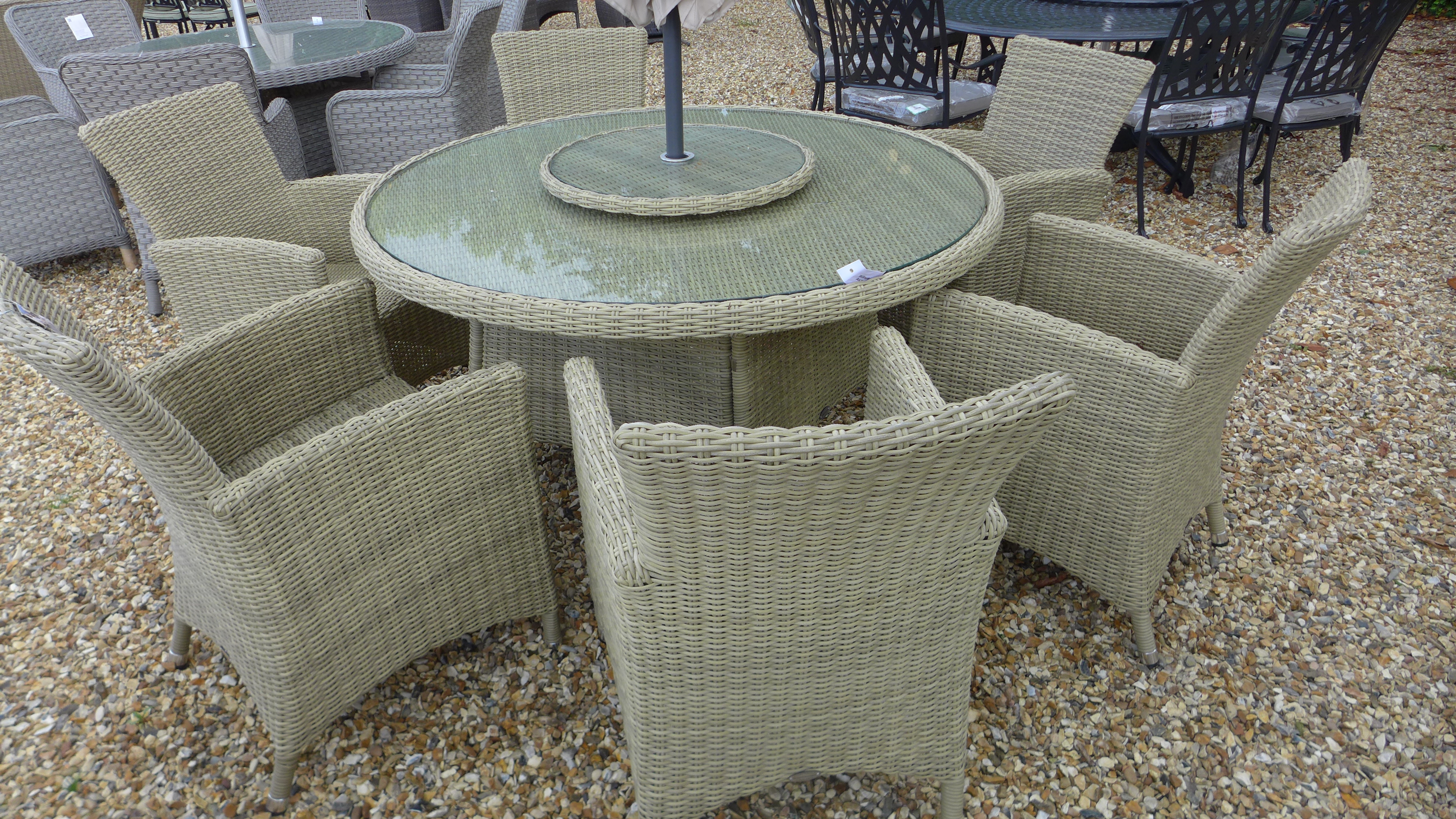 A Bramblecrest Cotswold 140cm round table with lazy susan, six armchairs,