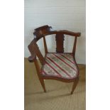 An Edwardian mahogany corner comfort chair