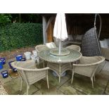 A Bramblecrest Sahara 130cm round table with four armchairs, lazy susan,