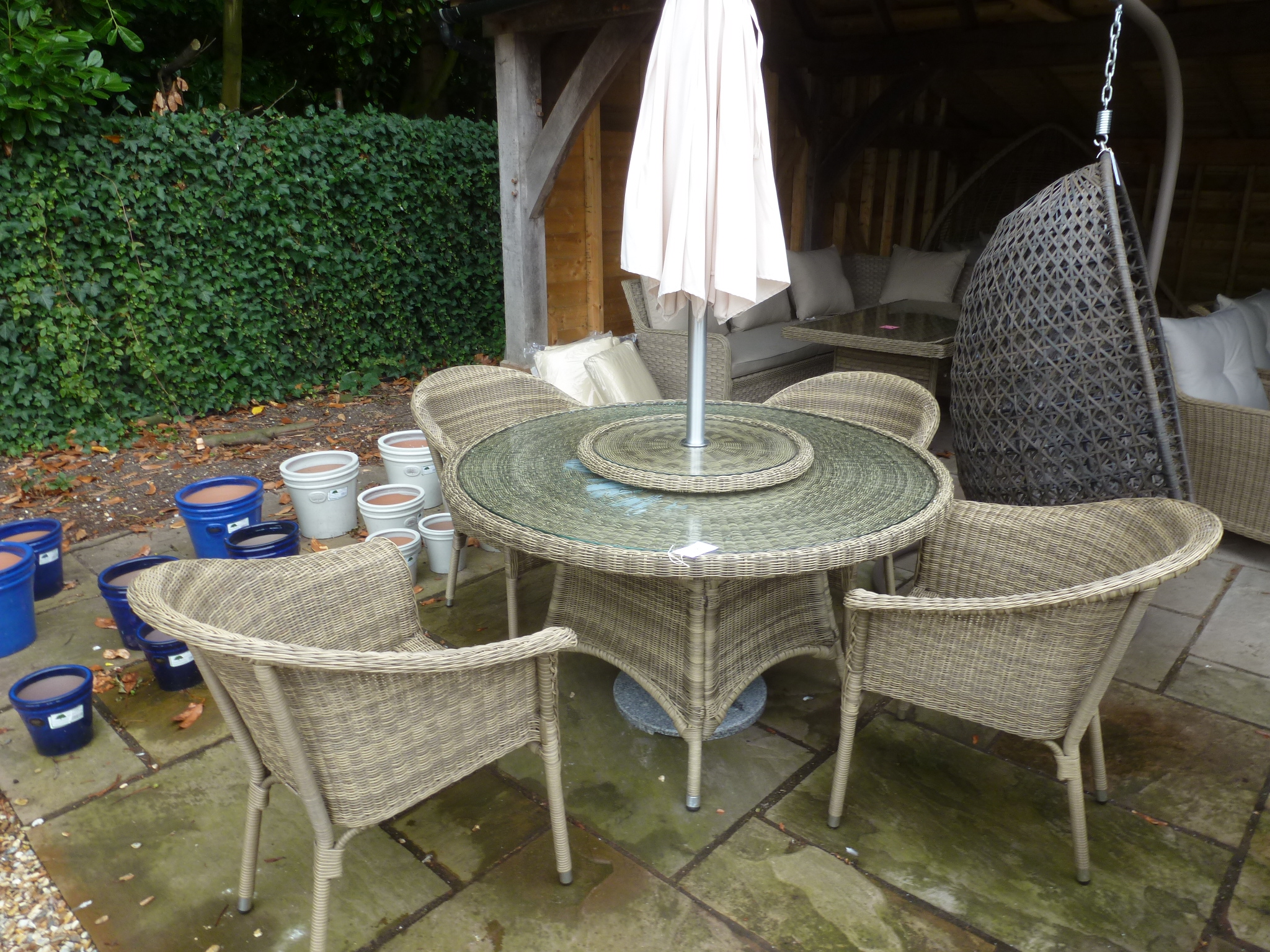 A Bramblecrest Sahara 130cm round table with four armchairs, lazy susan,