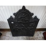 A decorative cast iron fire back - 76cm x 56cm