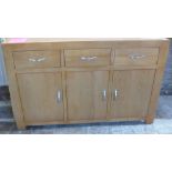 An ex display oak sideboard- with slight warping to top - Width 135cm - as new