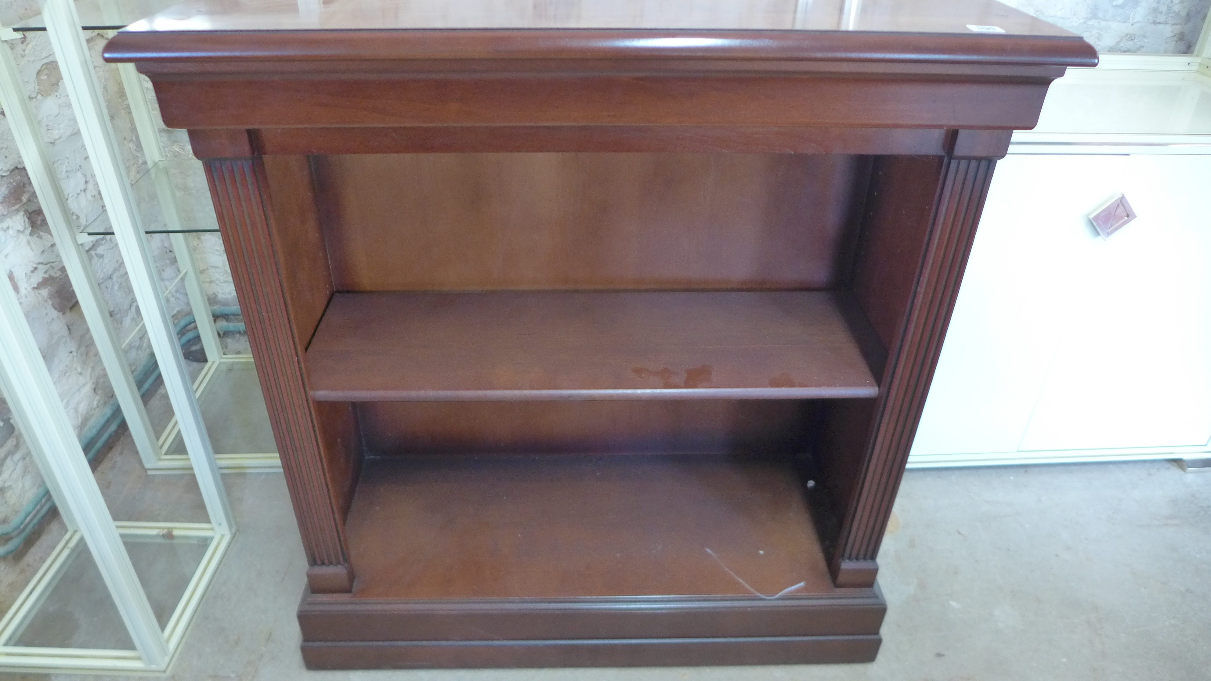 A modern mahogany bookcase with an adjustable shelf