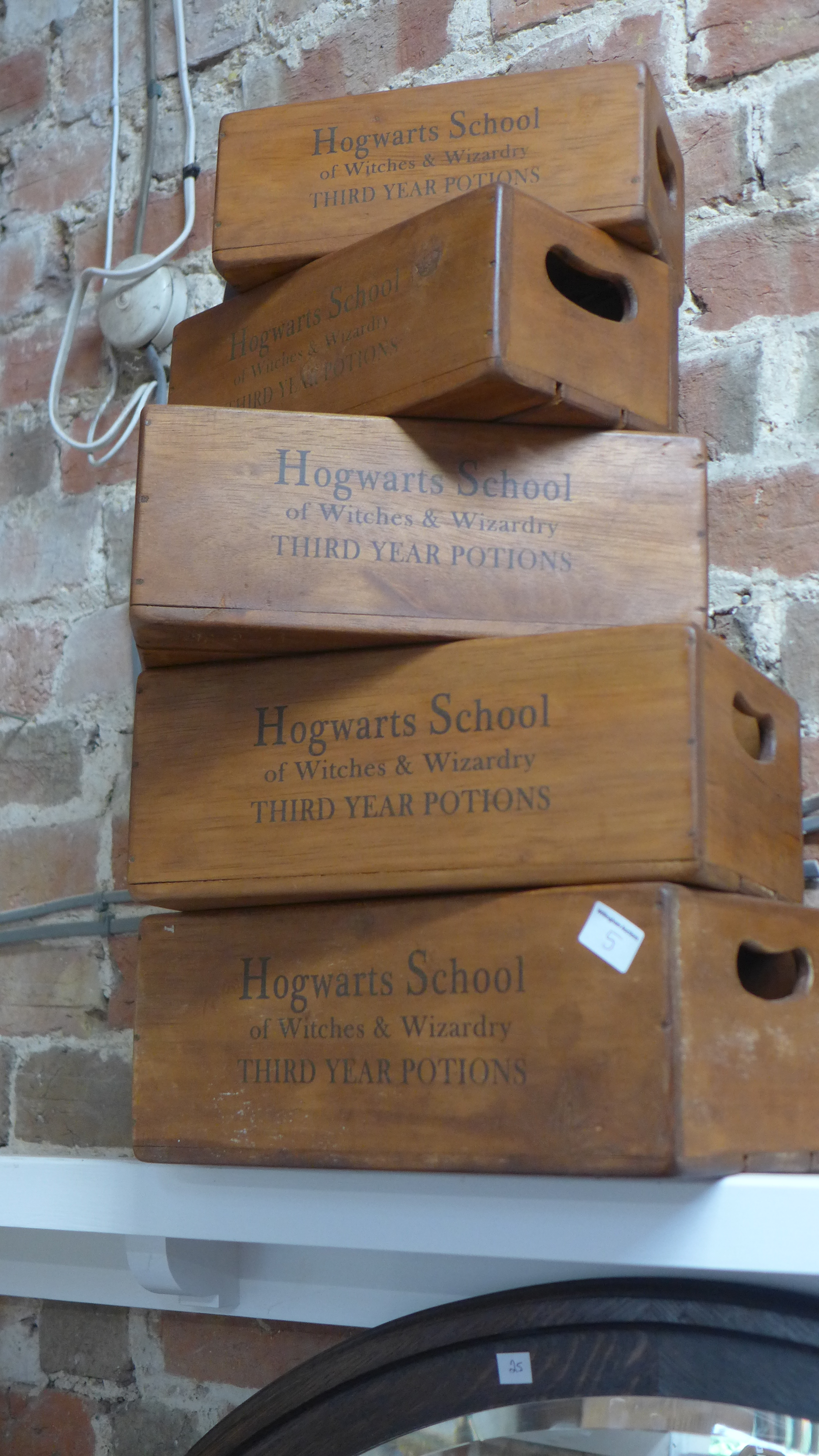 A set of five modern Hogwarts school boxes