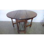 An 18th century oak gateleg table on bobbin turned supports with a drawer - Height 72cm x 81cm x