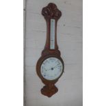 An oak aneroid barometer with thermometer - Height 85cm