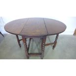 An 18th century oak gateleg table on bobbin supports - Height 22cm x 95cm x 124cm