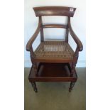 A 19th century mahogany childs chair on stand with a caned seat