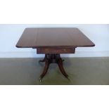 A Regency mahogany and ebony line inlaid Pembroke/breakfast table with a central turned column to a