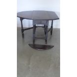 An 18th century oak gateleg table with later top and drawer in need of restoration,