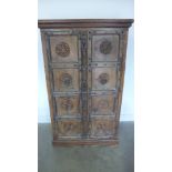 An Eastern carved two door cupboard with metal banding - height 169cm x 101cm x 53cm