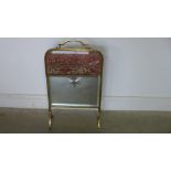 A brass fire screen with cut glass mirror centre