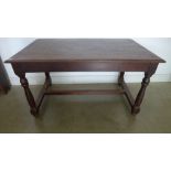 A Continental oak kitchen table on turned supports united by an H shaped stretcher - Height 73cm x