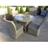 A Bramblecrest Sahara circular table with four chairs - Diameter 100cm