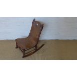 An early 20th century child's rocking chair with pierced Bentwood panel for splat and seat