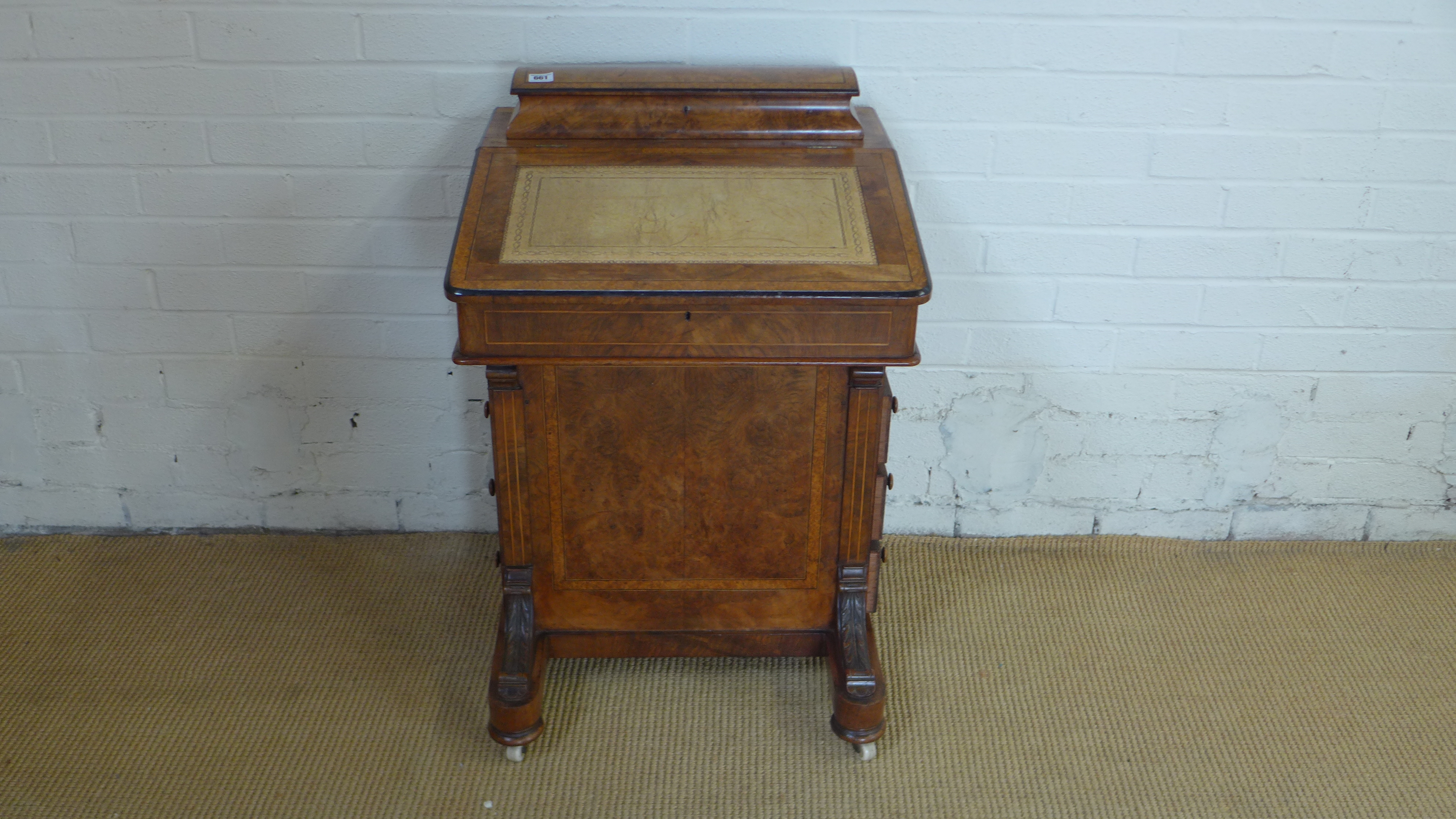 A Victorian walnut Davenport desk with a compartment above writing slope and four active drawers -