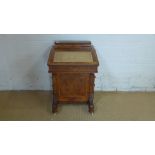 A Victorian walnut Davenport desk with a compartment above writing slope and four active drawers -