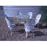 A set of six cast aluminium Victorian style garden chairs and a square table