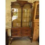 A walnut cabinet on chest with two glazed arched doors above four drawers on cabriole legs - Height