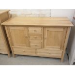 A John Lewis oak sideboard with two cupboard doors and five drawers - Height 88cm x 120cm x 50cm