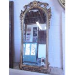 An ornate modern gilt mirror - 82cm x 38cm