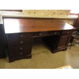 A modern hardwood twin pedestal desk with six drawers and a cupboard - Height 77cm x 175cm x 79cm