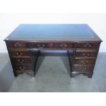 A modern mahogany twin pedestal nine drawer desk - Height 79cm x 152cm x 90cm