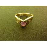 An 8ct yellow gold ring marked 333 set with two diamonds and a centre pink stone - Ring size M/N -