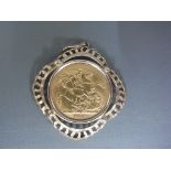 A George V full Sovereign in a 9ct yellow gold pendant mount, weight approx 10.