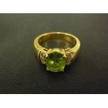 An 18ct yellow gold peridot and diamond ring - Size M - Weight approx. 7.