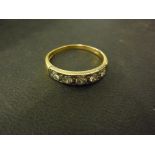 An 18ct yellow and white gold five stone diamond ring - size S - centre stone approx.