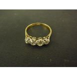 An 18ct yellow gold four stone diamond ring - larger diamond approx .