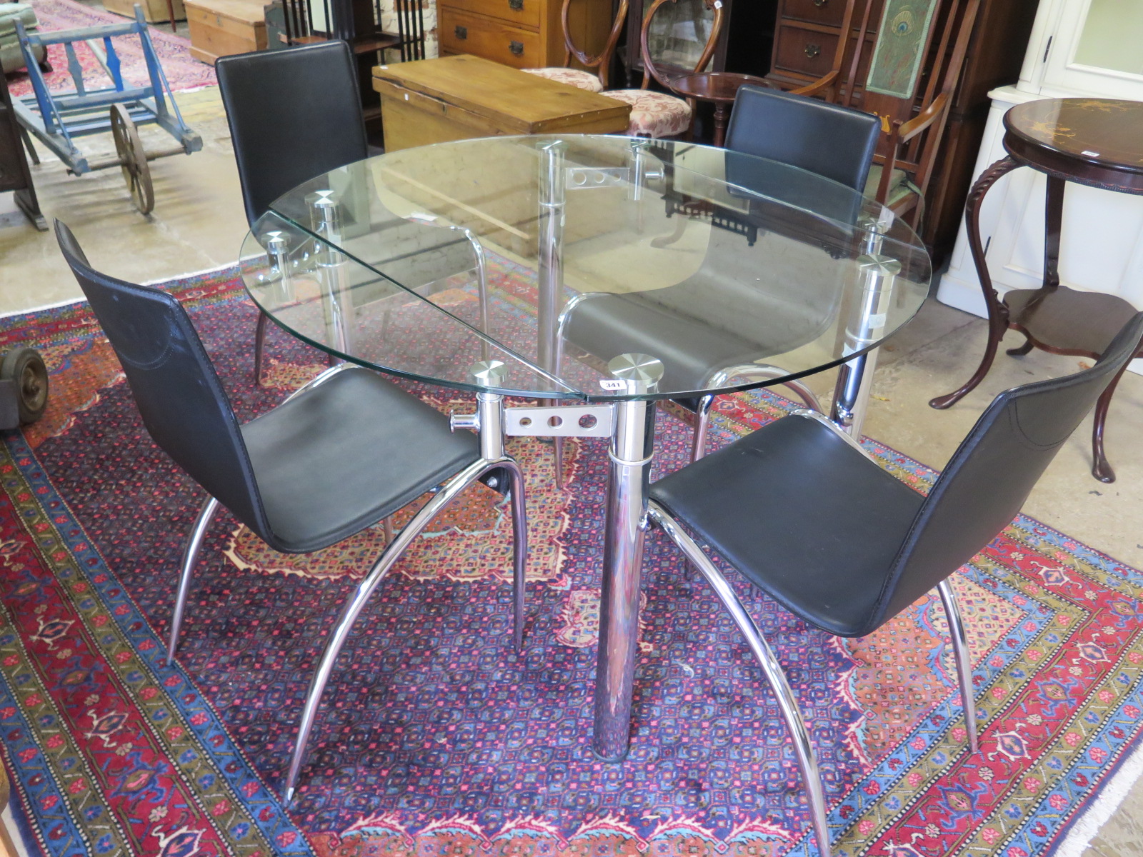 A Swedish glass and chrome extending table with four chairs - 115cm x 115cm extended