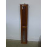 A glazed walnut barometer case - Height 129cm x 21cm x 17cm