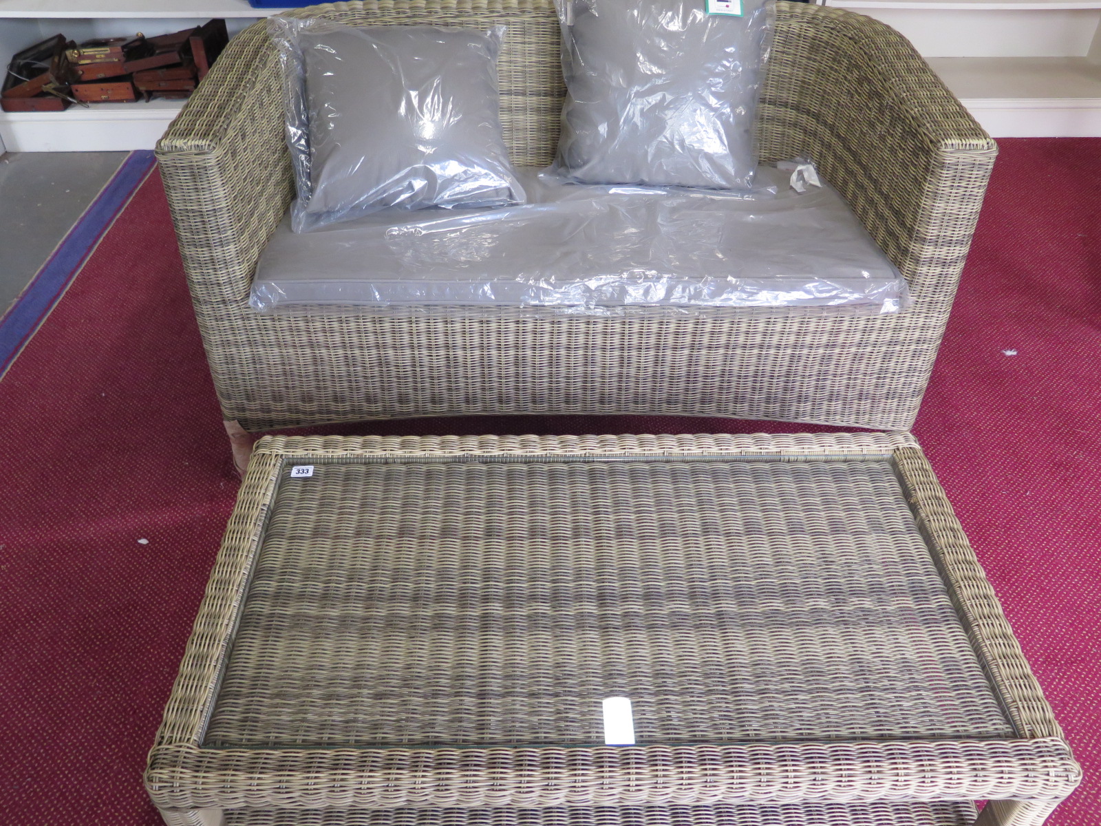 A Bramblecrest Sahara Classic two seater sofa with cushion and a coffee table - slight damage to