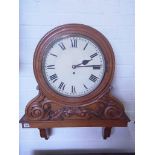 A carved oak gallery clock with a 12" painted dial and fusee movement - Height 29" x Width 24" -