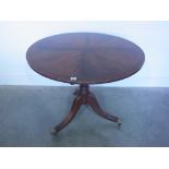 A mahogany antique style round table on a tripod base - Height 76cm x Diameter 91cm