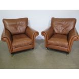 A pair of modern Laura Ashley leather tan armchairs - Height 90cm x Width 93cm x Depth 100cm