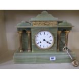 A 19th century green onyx mantle clock strikes on a bell