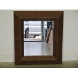 A modern brown leather framed mirror - 85cm x 75cm
