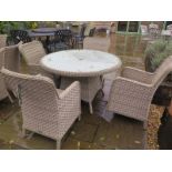 A Bramblecrest Patagonia 120cm round table with four armchairs,