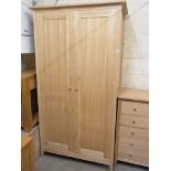 An oak two door wardrobe - Height 209cm x 113cm x 63cm