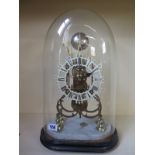 A brass skeleton clock with a single fusee movement under a glass dome - Total height 46cm