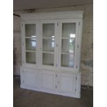 A Laura Ashley ivory Provencale cabinet with three glazed doors above a three door cupboard base -