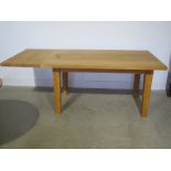 A solid oak dining table with extension leaf,