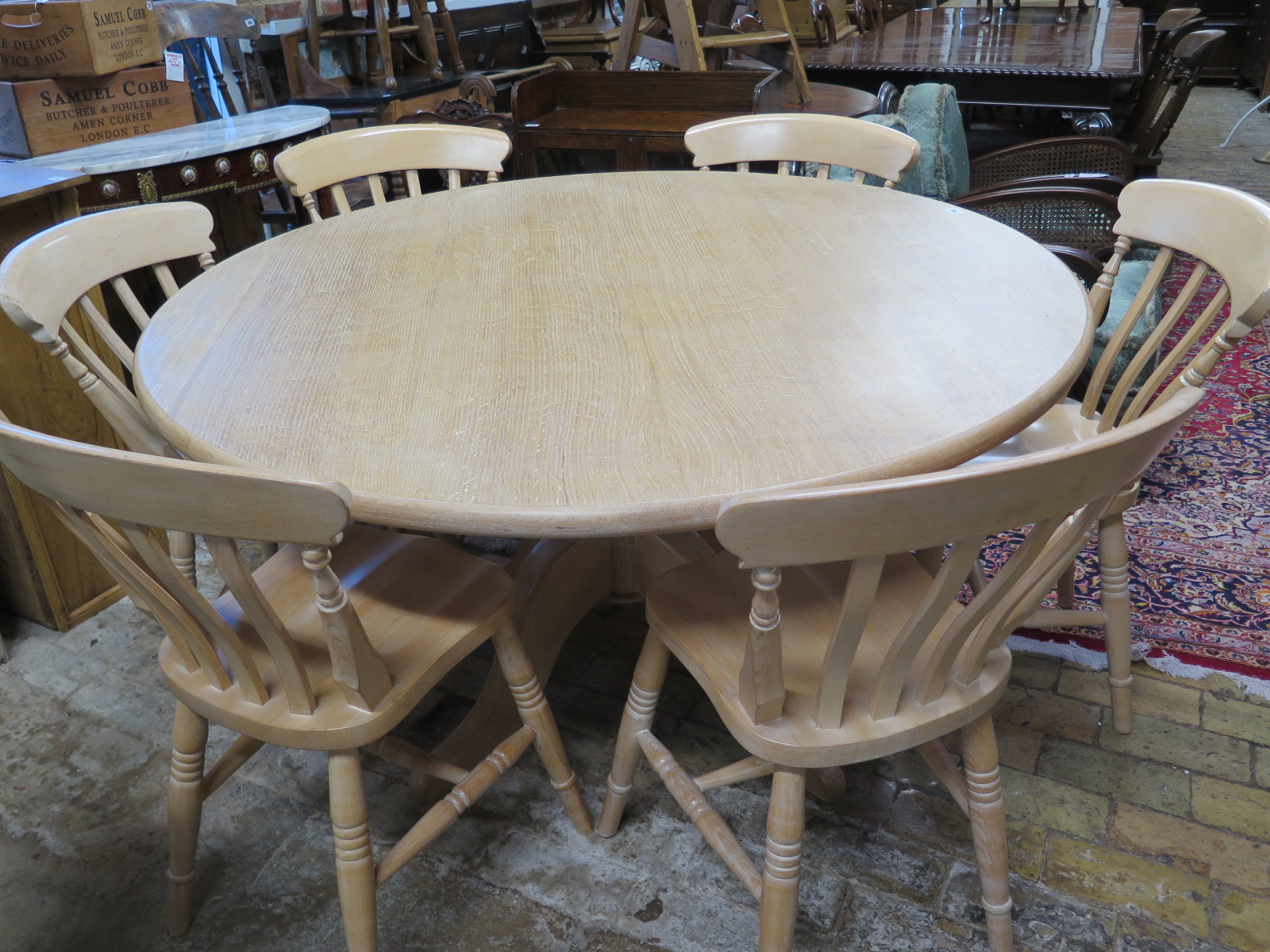 A circular lined oak dining table made by Turners Cabinet makers of Cambridge - Height 75cm x