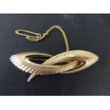 A 9ct yellow gold brooch with safety chain - Length 6cm - approx weight 6 grams - clean condition