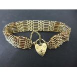 A 9ct yellow gold 7 bar bracelet with padlock clasp - approx weight 25 grams - clean condition,