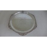 A silver hallmarked salver with gadrooned boarder and three foliate design feet the salver engraved