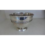 A silver hallmarked bowl on single circular pedestal base with embossed ribbed design around centre,